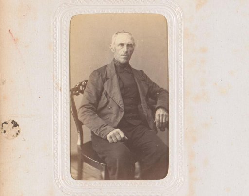 Portrait of a man, seated at a table