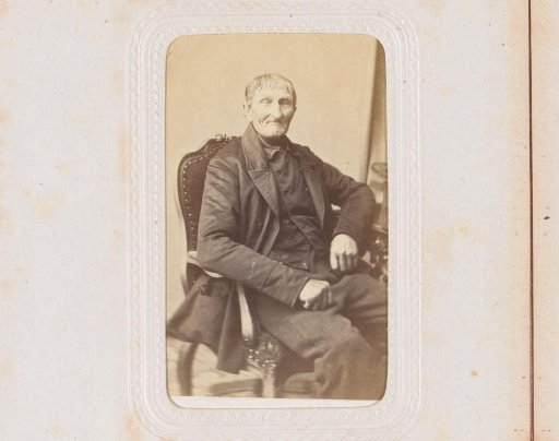 Portrait of a man, seated at a table