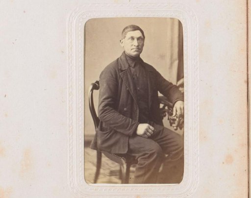 Portrait of a man, seated at a table
