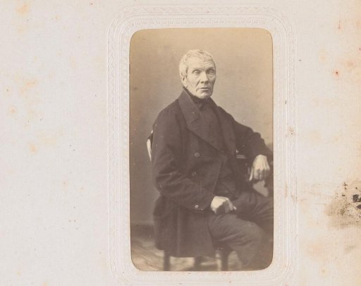 Portrait of a man, seated at a table