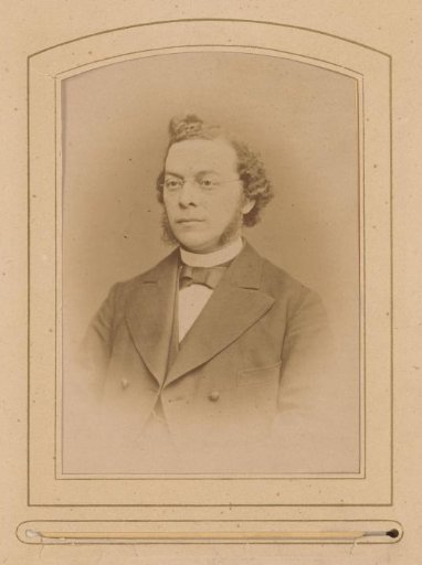 Portrait of a man with sideburns and glasses, identified as P.A. Schramm