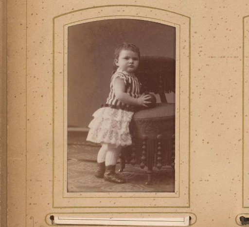 Portrait of a Toddler with a Ball in His Hand, Standing by a Chair