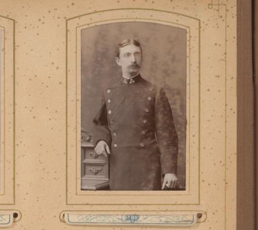 Portrait of a standing man with a mustache and glasses