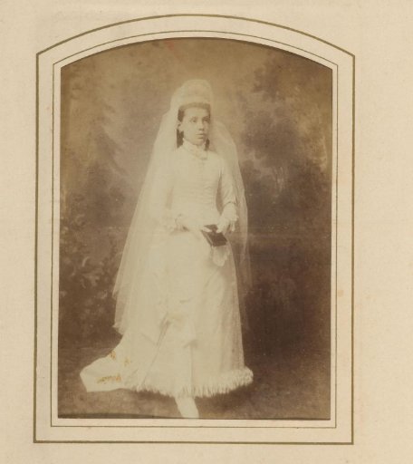 Portrait of a young woman in a wedding dress holding a book, designated as Aunt Bets