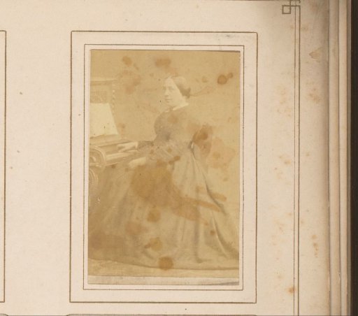 Portrait of a seated woman at a piano, identified as Mrs. Niehof-Dellemijn