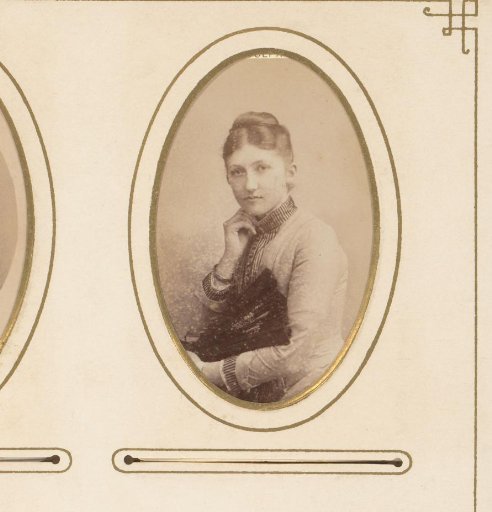 Portrait of a young woman holding a fan
