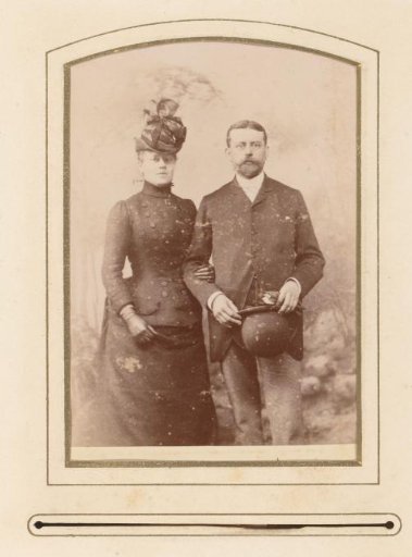 Portrait of a woman with a hat and a man holding a hat