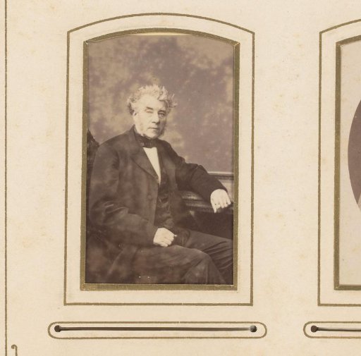 Portrait of a man seated at a table