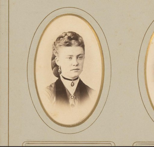 Portrait of a woman with a necklace and a braid in her hair