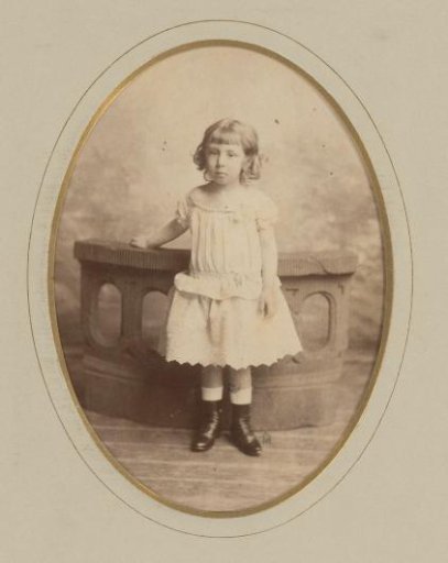 Portrait of a girl standing before a balustrade