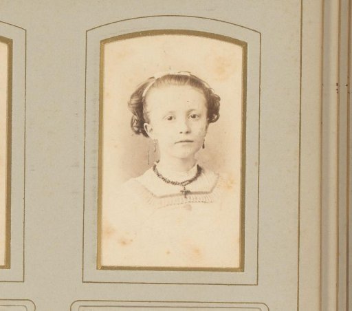 Portrait of a girl with a necklace featuring a cross
