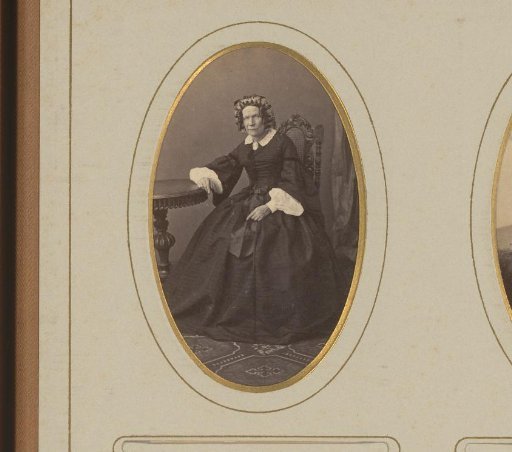 Portrait of a woman seated at a table