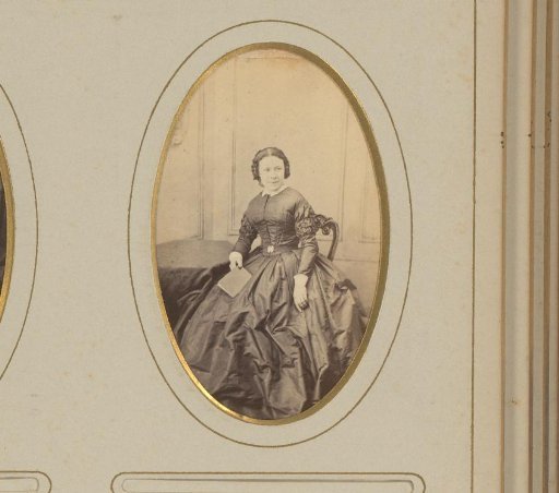 Portrait of a seated woman with a book in her hand