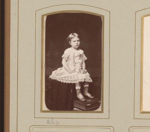 Portrait of a girl, seated on a table with her feet resting on a book, identified as Alix