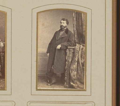 Portrait of a standing man, leaning on a balustrade