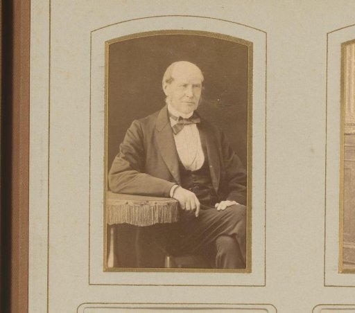 Portrait of a man seated at a table