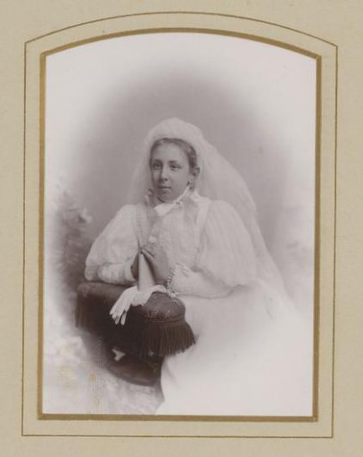 Portrait of a girl with veil and book in her hands