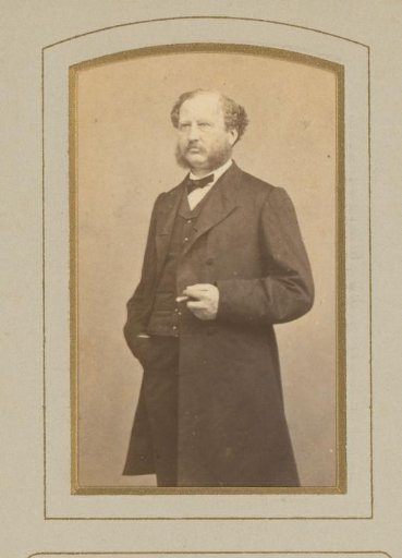Portrait of a standing man with a cigar in his hand