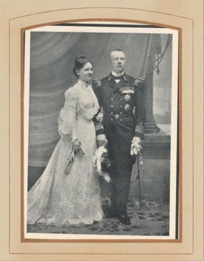 Portrait of a married couple, woman in a wedding dress, man in military uniform