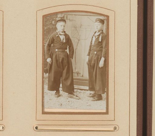 Portrait of Two Boys by a Chicken Coop