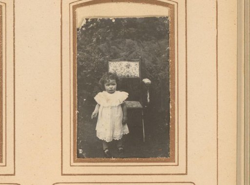 Portrait of a girl, outside by a chair