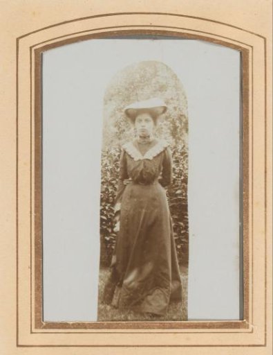 Portrait of a standing young woman with a hat