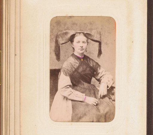 Portrait of a woman in traditional dress with cap and shawl