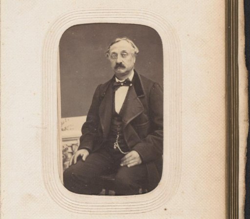 Portrait of a seated man with a moustache
