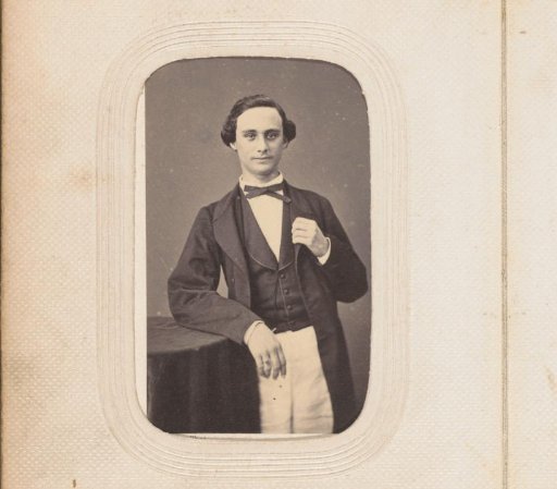 Portrait of a standing young man with a bow tie