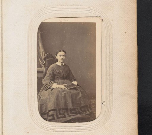 Portrait of a sitting girl with a book on her lap