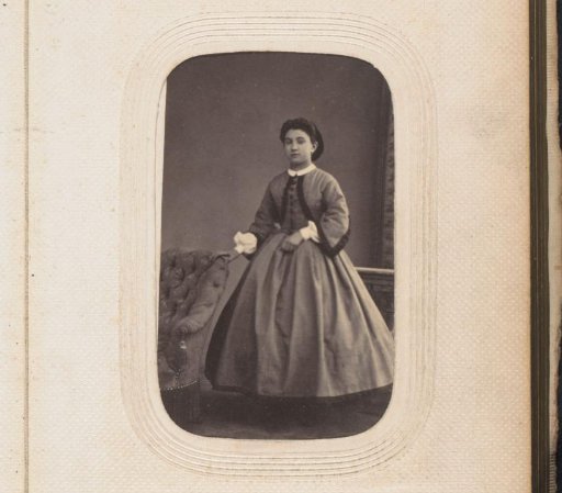 Portrait of a standing girl by a chair