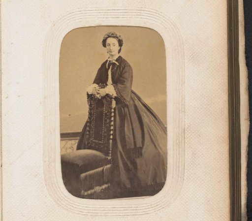 Portrait of a standing woman by a chair