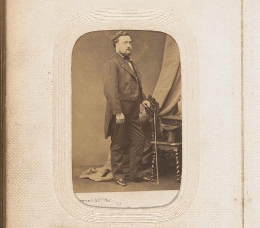 Portrait of a standing man with a walking stick