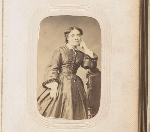Portrait of a standing woman leaning on a chair