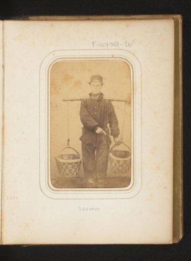 Portrait of a man in traditional dress, presumably from Zeeland, with a yoke and buckets
