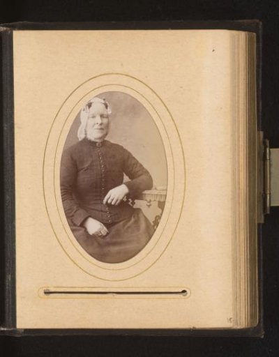 Portrait of a seated woman with a cap