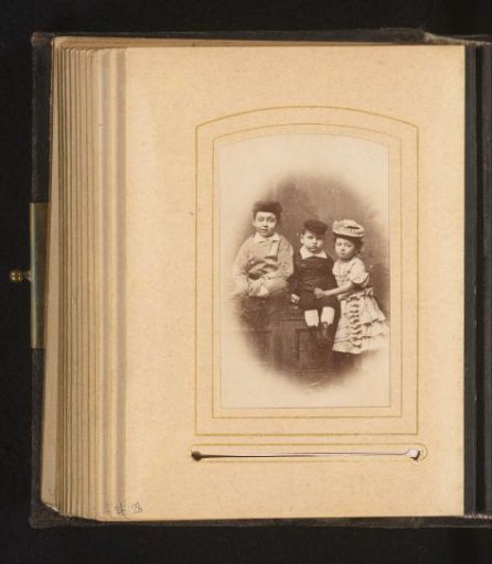 Group portrait with three children wearing hats