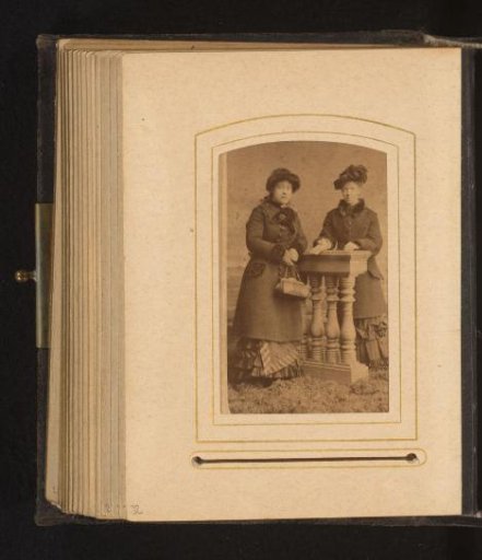 Portrait of two standing women with hats