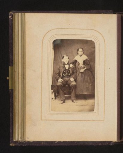 Portrait of a seated man with sideburns and a woman