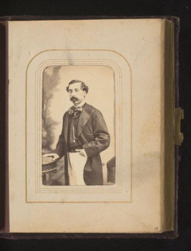 Portrait of a standing man with a moustache