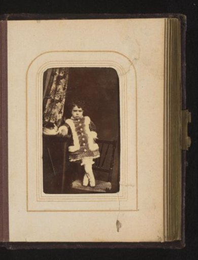 Portrait of a Boy Standing on a Chair