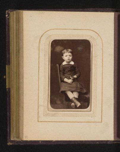 Portrait of a Child Sitting on a Chair