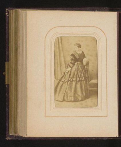 Portrait of a standing woman, identified as Ramona