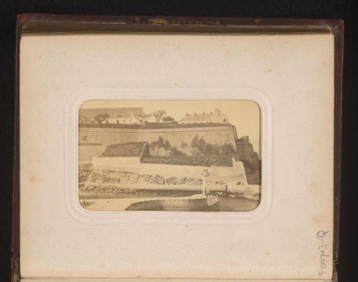 View of the ramparts of a seaside town with a lighthouse