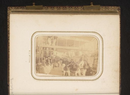 Crew members on the deck of a ship, standing by the rigging