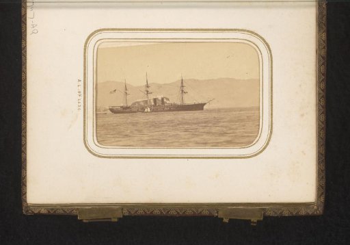 Ship at sea before a mountain range