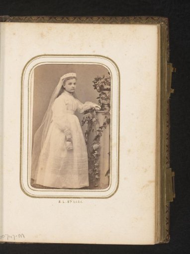 Portrait of a standing girl in a communion dress