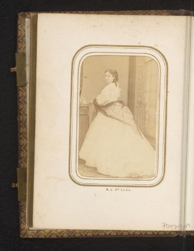 Portrait of a standing young woman in a dress