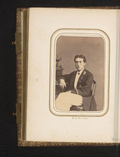 Portrait of a seated young man in uniform