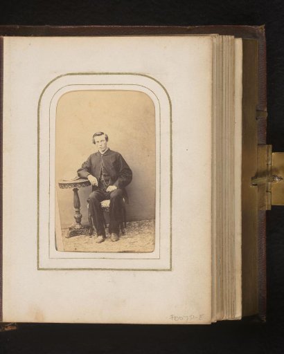 Portrait of a seated young man at a table